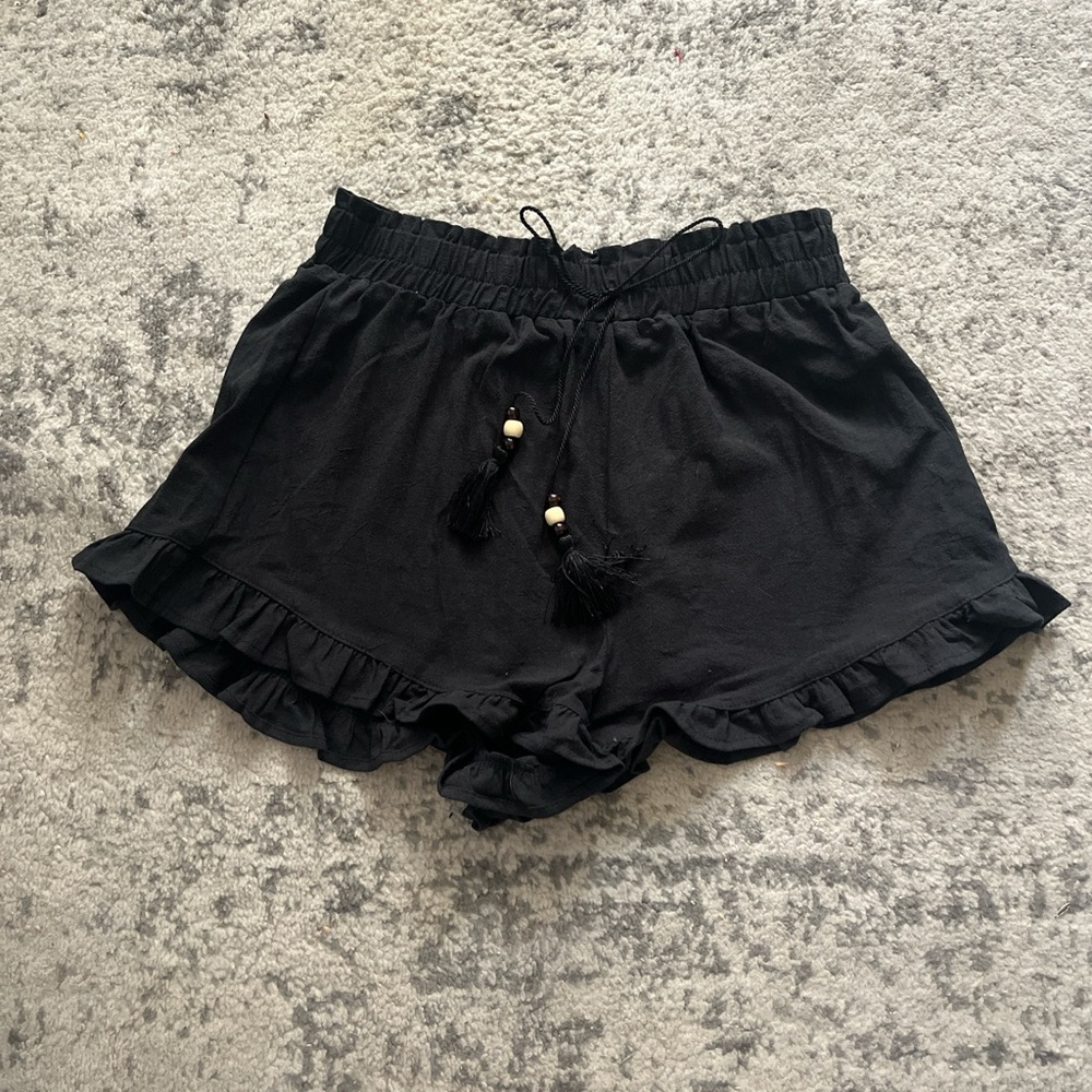 Black ruffle shorts with tassel detail